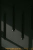 three telephones are hanging on a wall