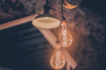 a couple of light bulbs hanging from a ceiling