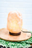 a himalayan lamp sitting on top of a wooden stand