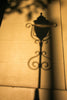 a shadow of a street light on a sidewalk