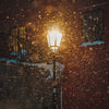 a street light in the snow at night