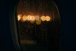 a window with rain drops on it at night