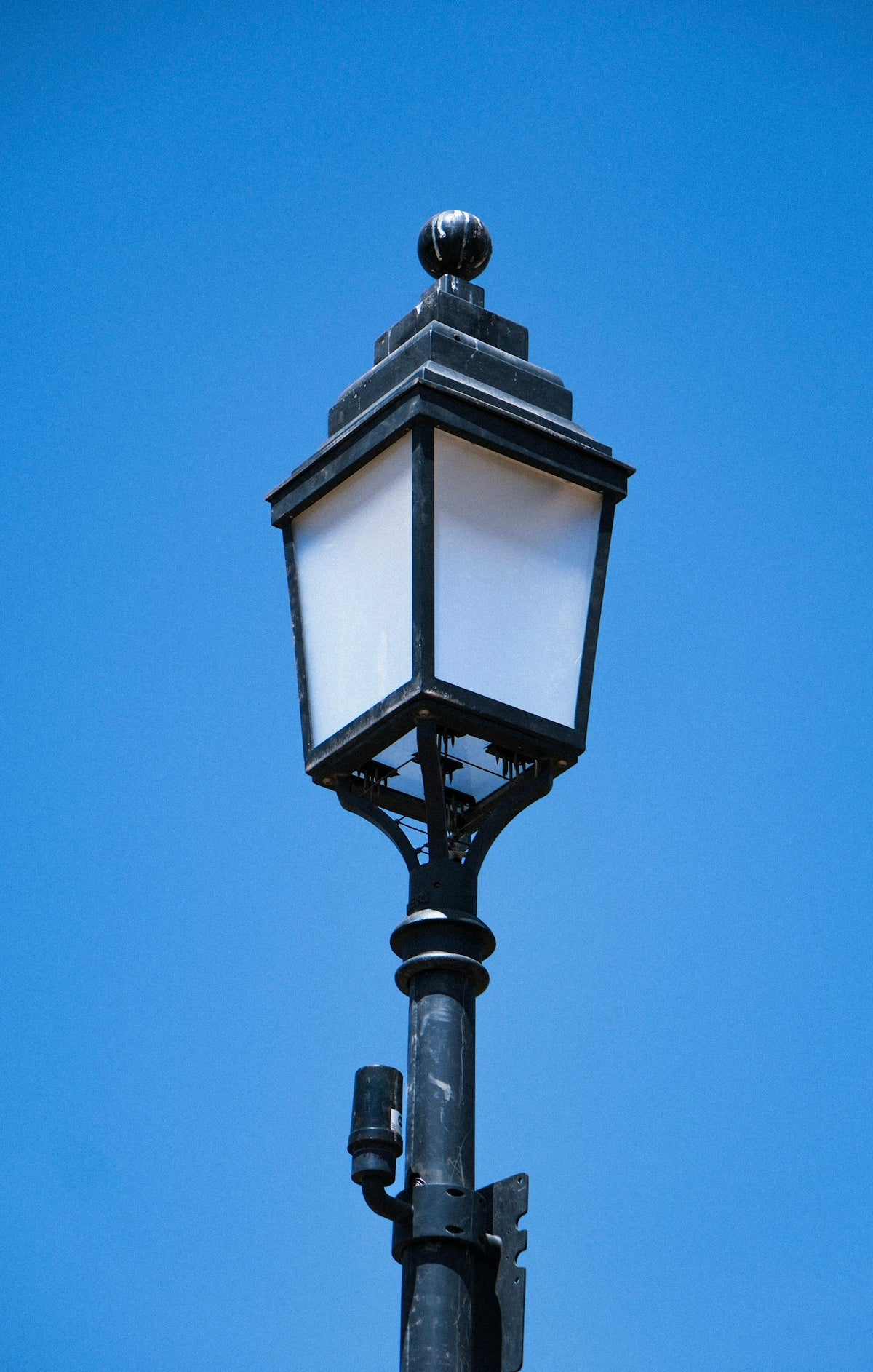 a street light with a clear blue sky in the background