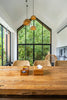 A large wooden table in front of a large window