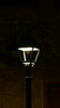 A lamp post lit up in the dark