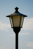 A lamp post with a blue sky in the background