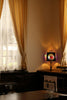 A dimly lit room with a clock on the wall