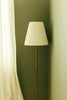 A tall floor lamp with a white shade.