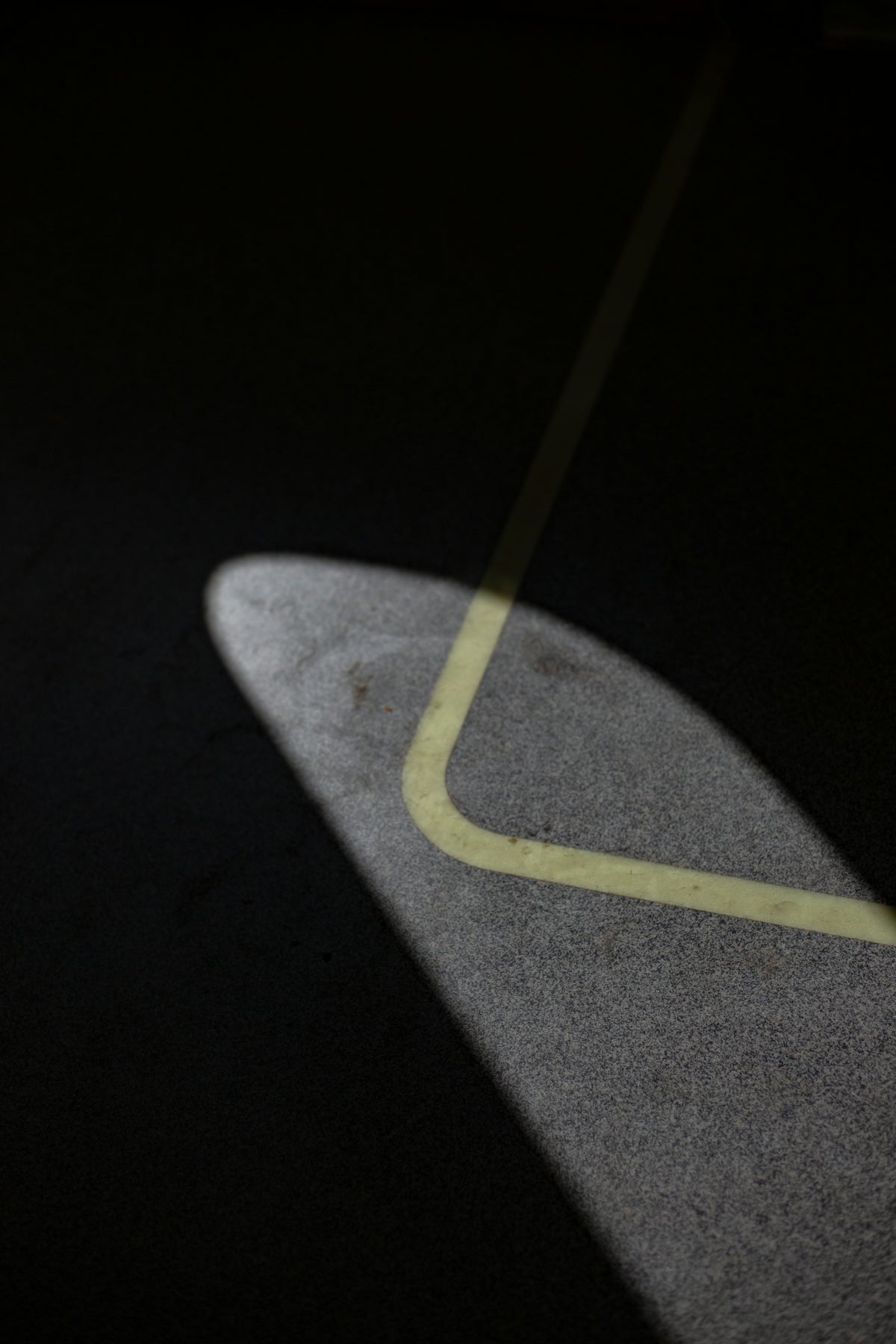 the shadow of a skateboard on the ground