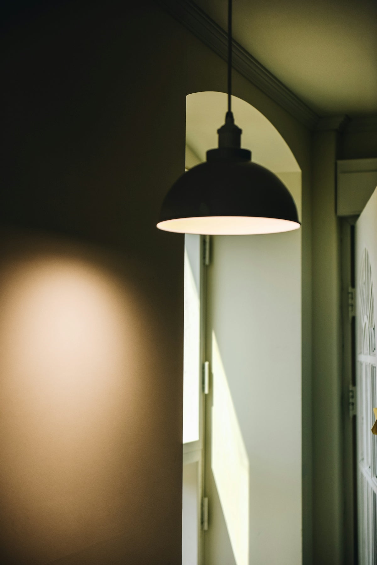 black pendant lamp near window and door
