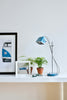 a picture of a vw bus on a shelf next to a lamp and a