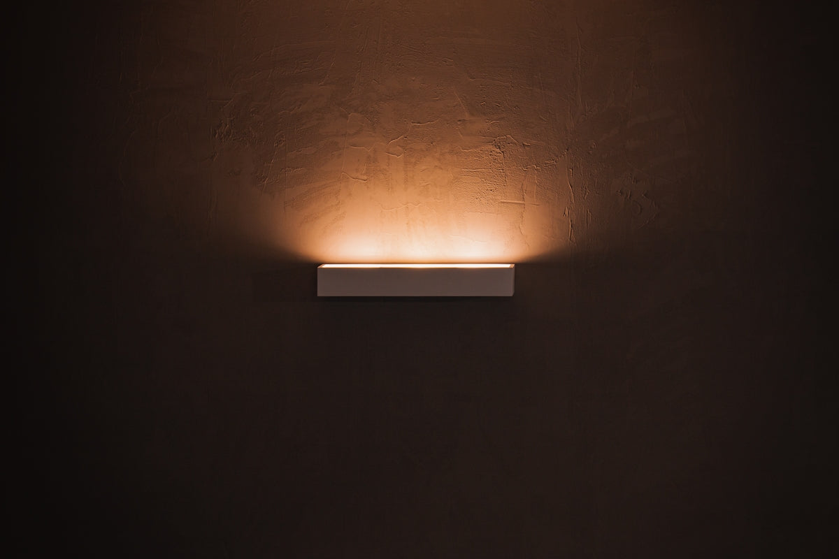 white light bulb turned on in dim lit room