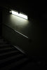white ceramic tiled staircase with stainless steel railings