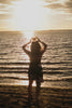 man in black shorts standing on sea shore during daytime