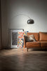 brown wooden framed white padded armchair beside white wall