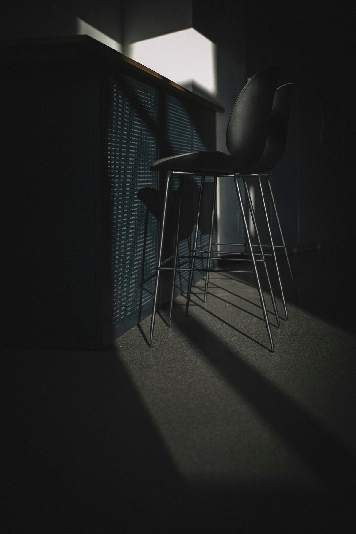 black leather padded chair near window