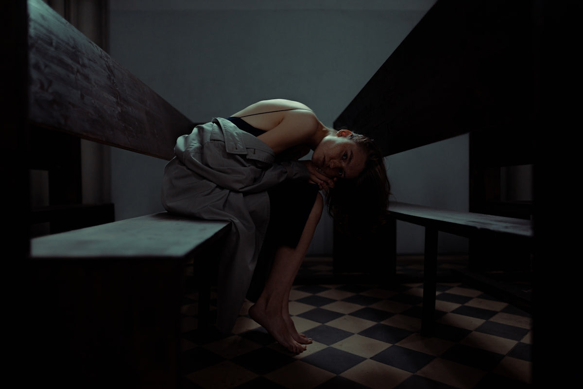 woman in gray dress lying on bed