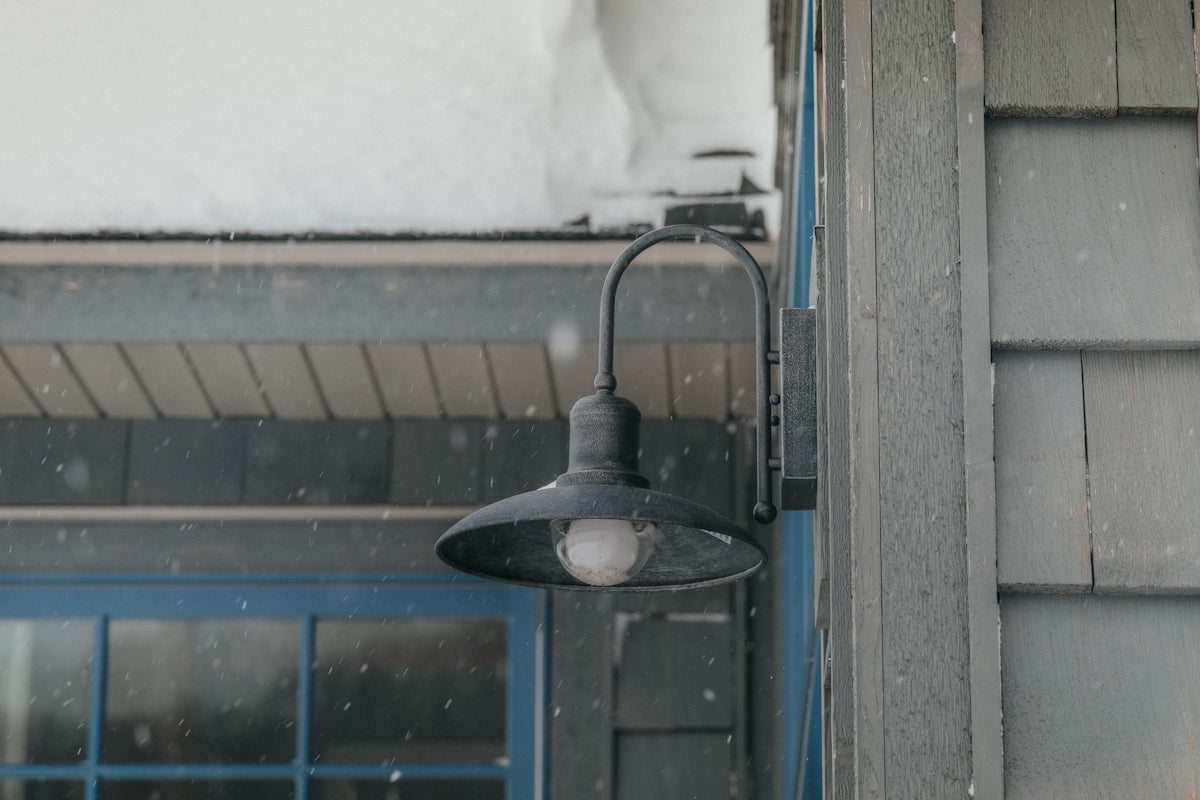 a street light on a snowy day outside a building