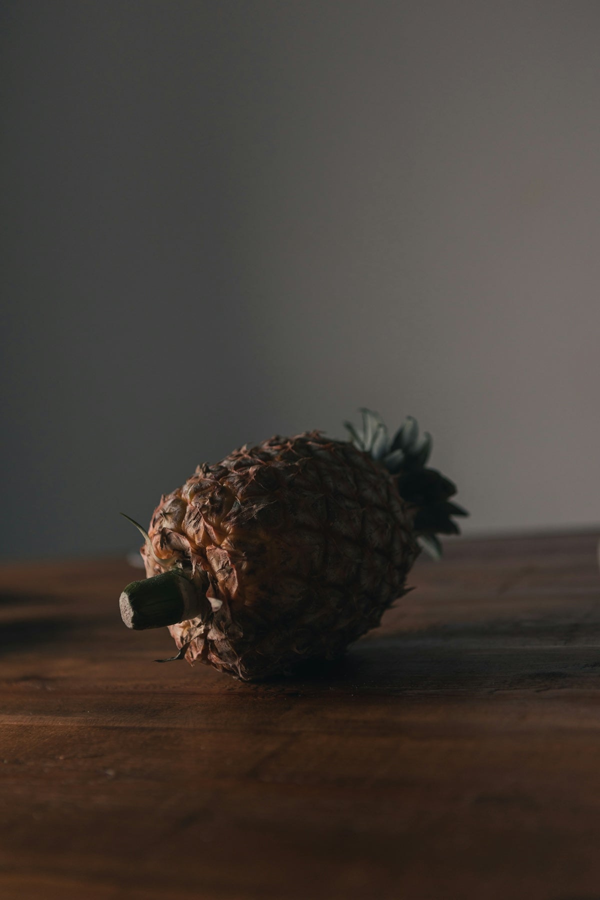 a pineapple sitting on top of a wooden table