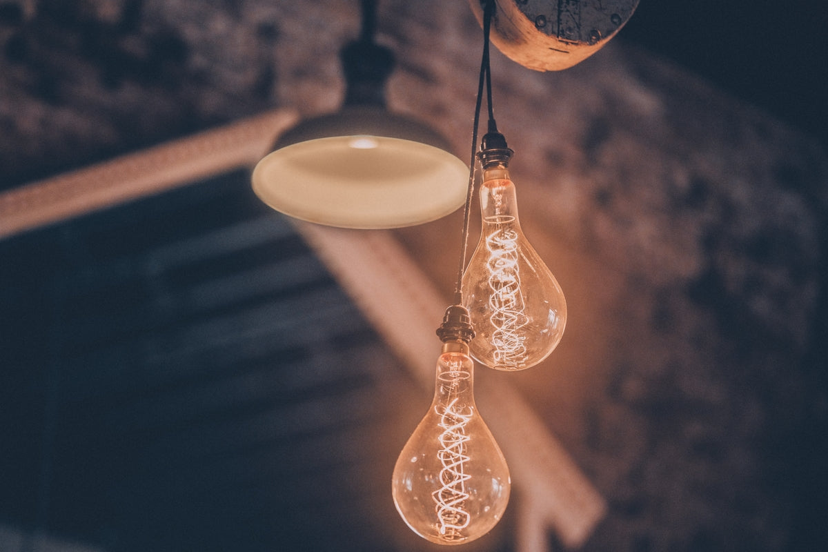 a couple of light bulbs hanging from a ceiling