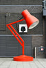 a red lamp sitting on top of a red table