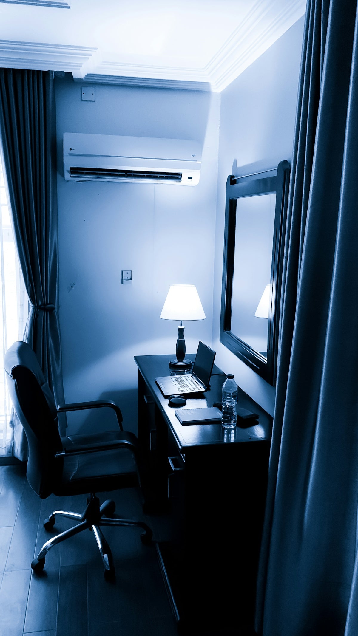 a desk with a lamp and a mirror