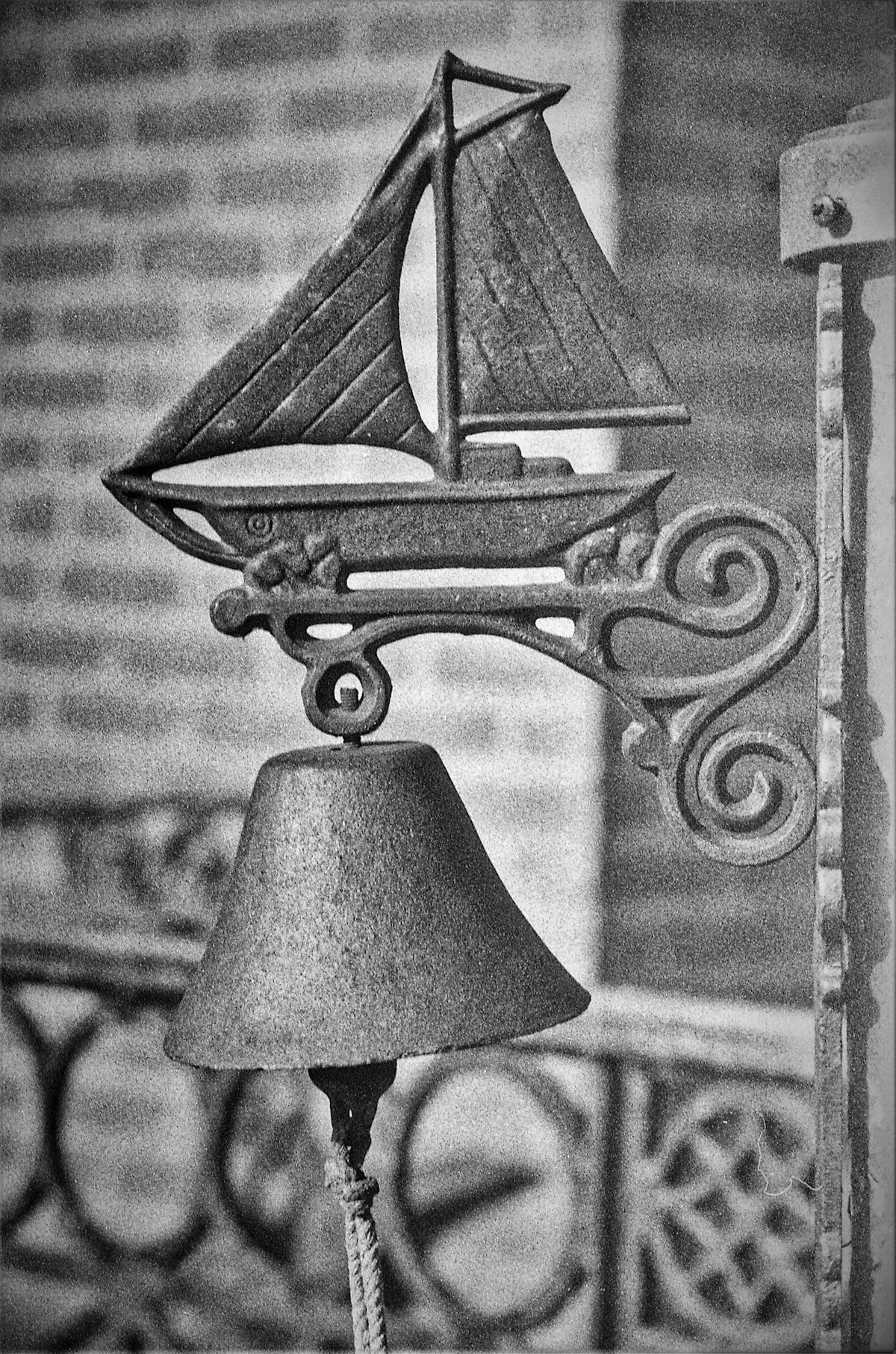 a black and white photo of a lamp with a sailboat on it