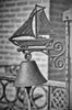 a black and white photo of a lamp with a sailboat on it