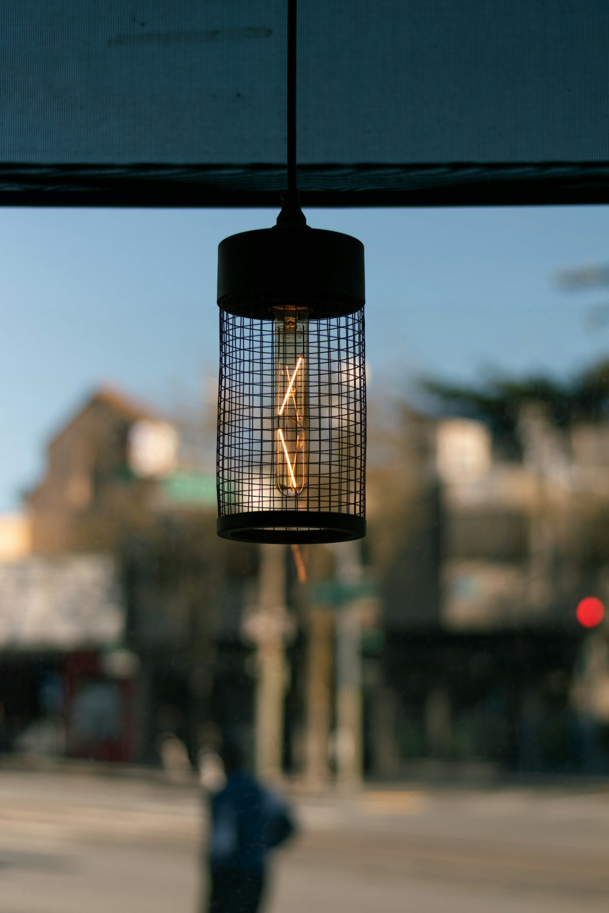 a birdcage hanging from the side of a building