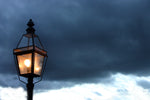 a street light with a cloudy sky in the background