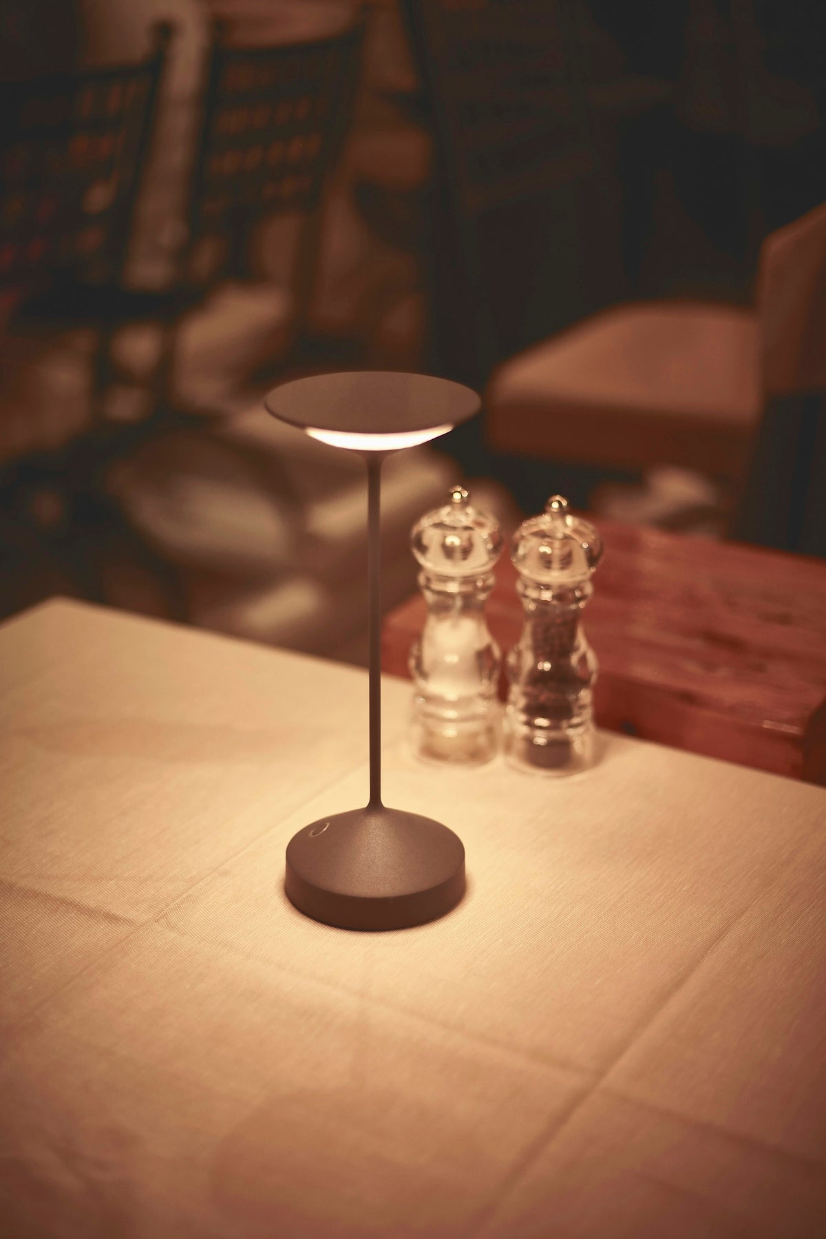 a table with two glass salt and pepper shakers on it