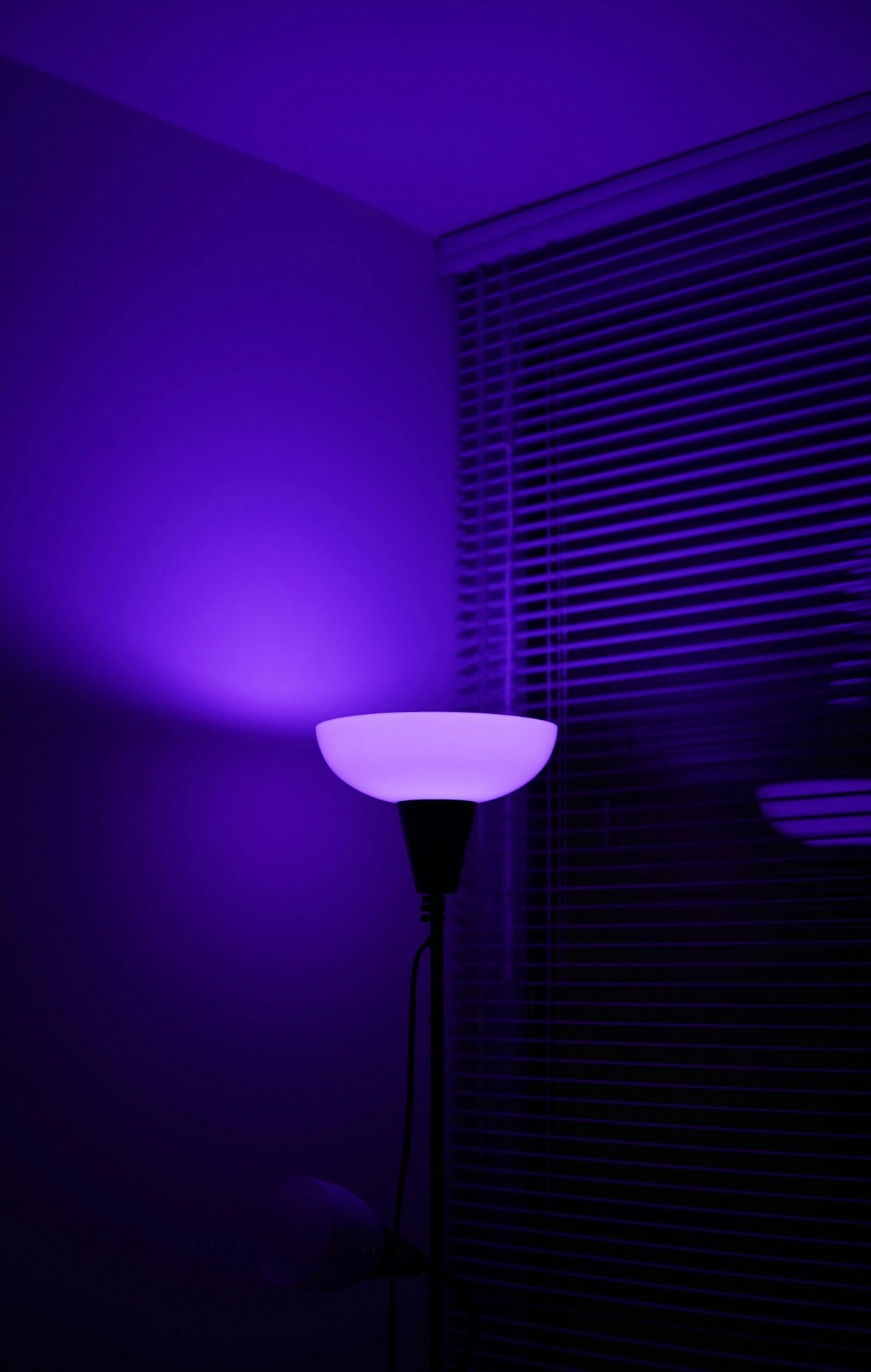 a purple light shines on a dark room