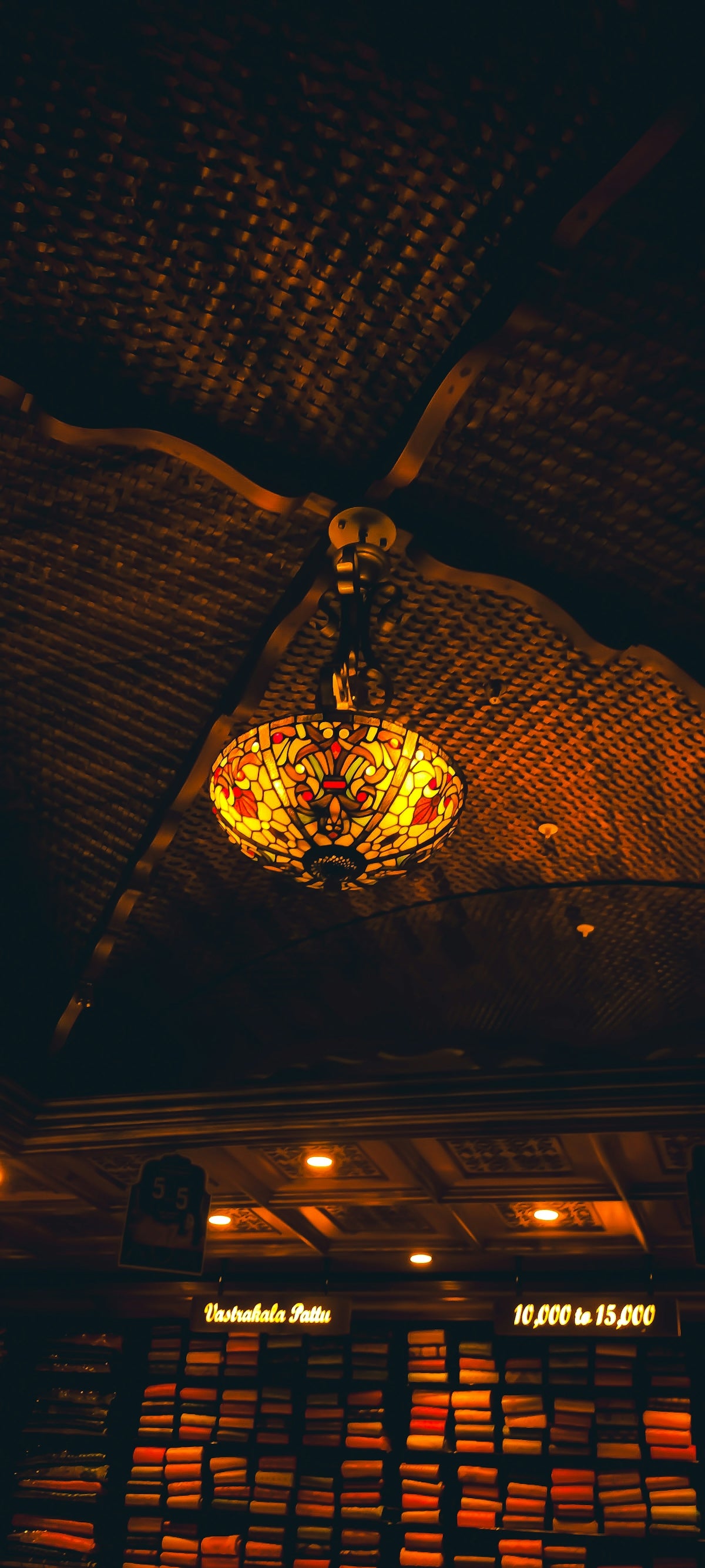 a stained glass light hanging from the ceiling