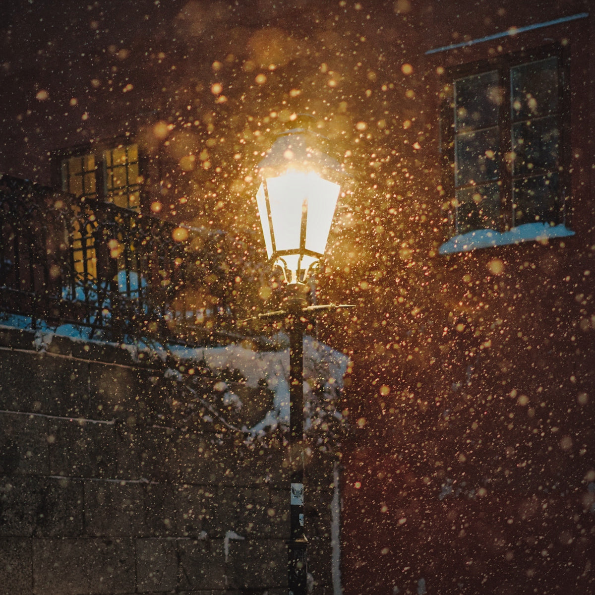 a street light in the snow at night