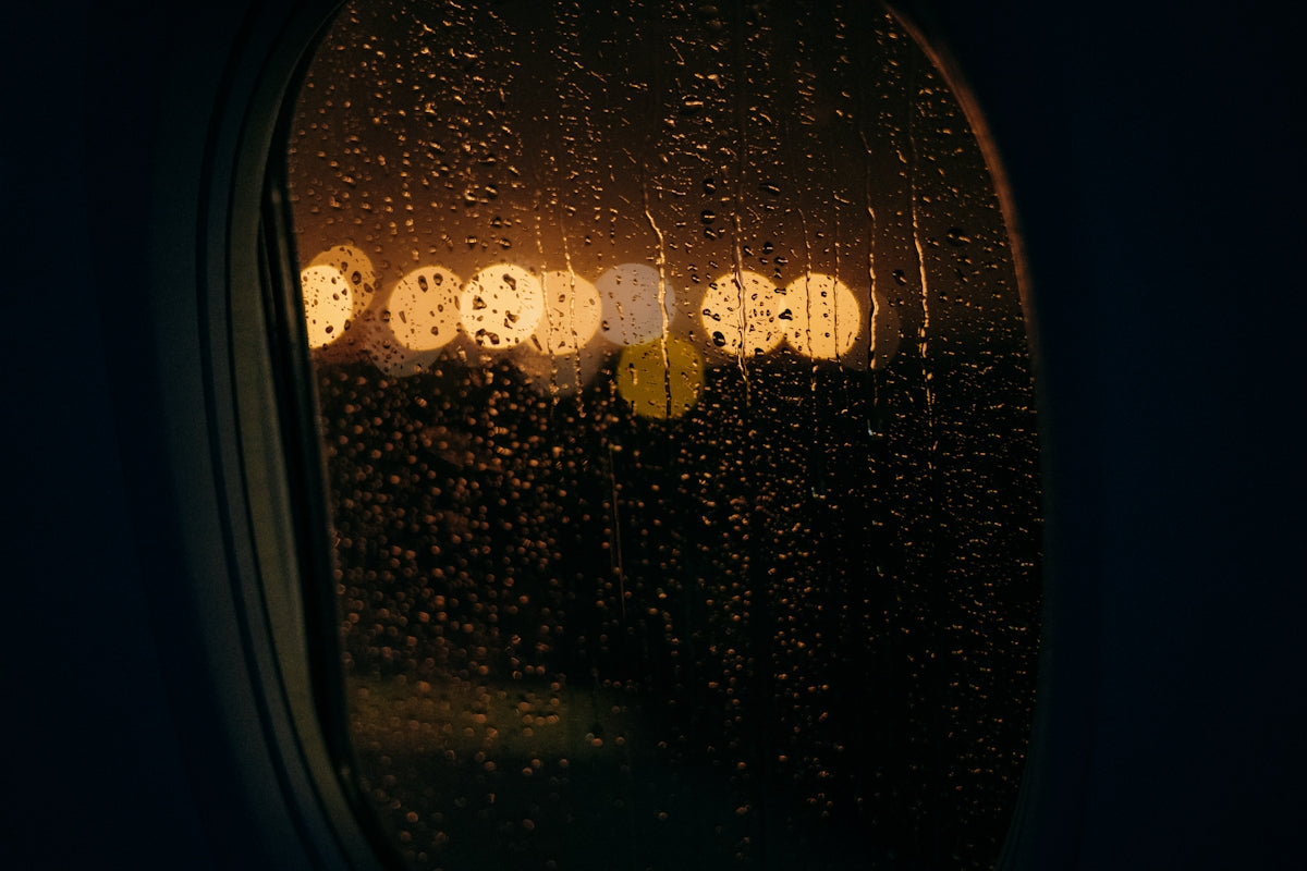 a window with rain drops on it at night