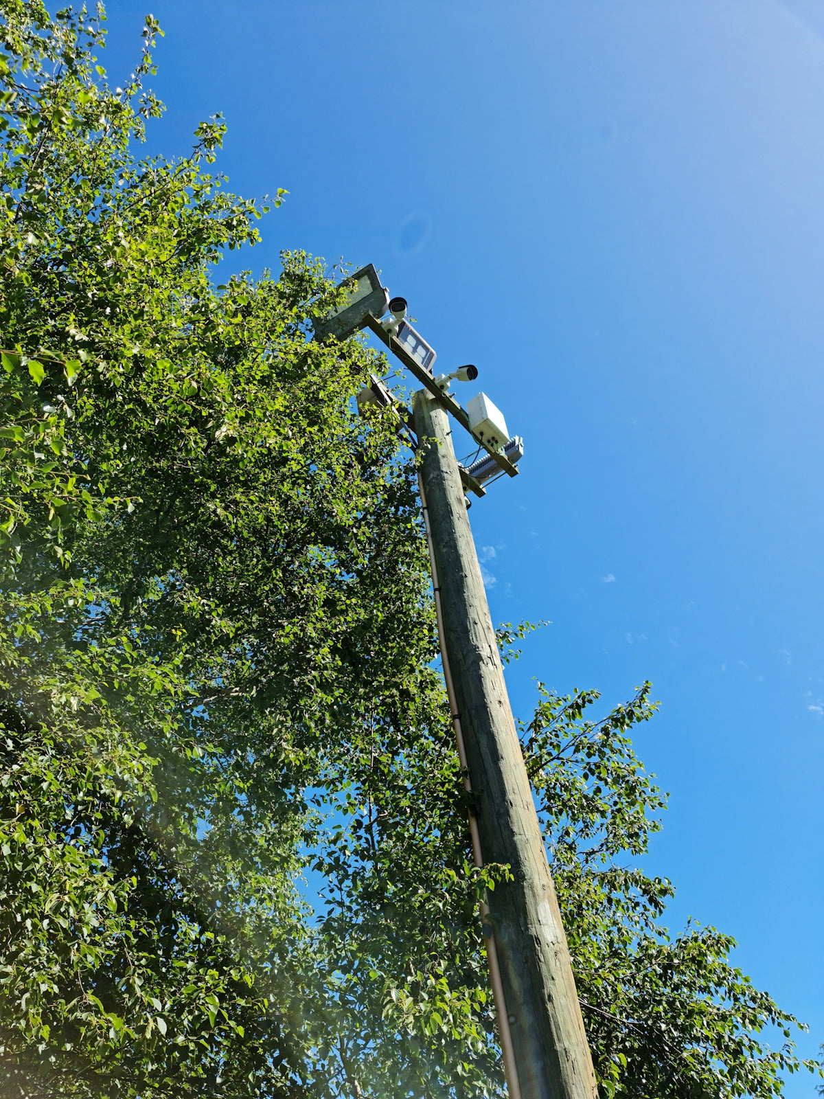 a telephone pole with a car on top of it