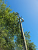 a telephone pole with a car on top of it