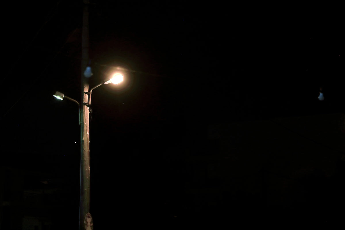 a street light on a dark street at night