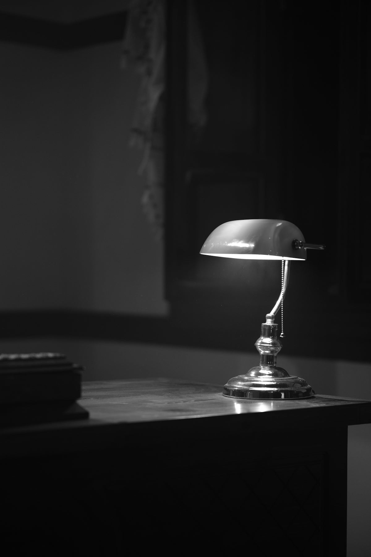 a desk lamp sitting on top of a wooden desk