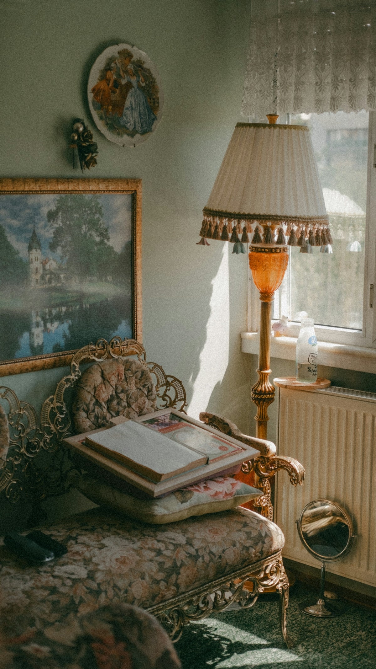 a room with a bed, a lamp and a picture on the wall