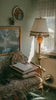 a room with a bed, a lamp and a picture on the wall