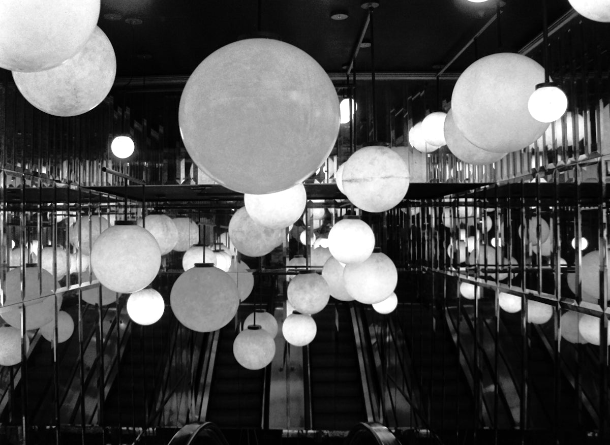A room filled with lots of white balloons