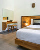 A bedroom with a large bed and a mirror