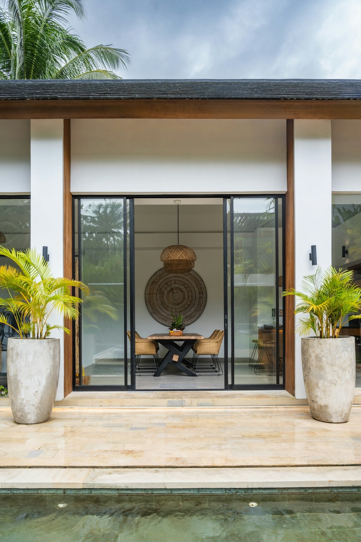 A house with a pool in front of it