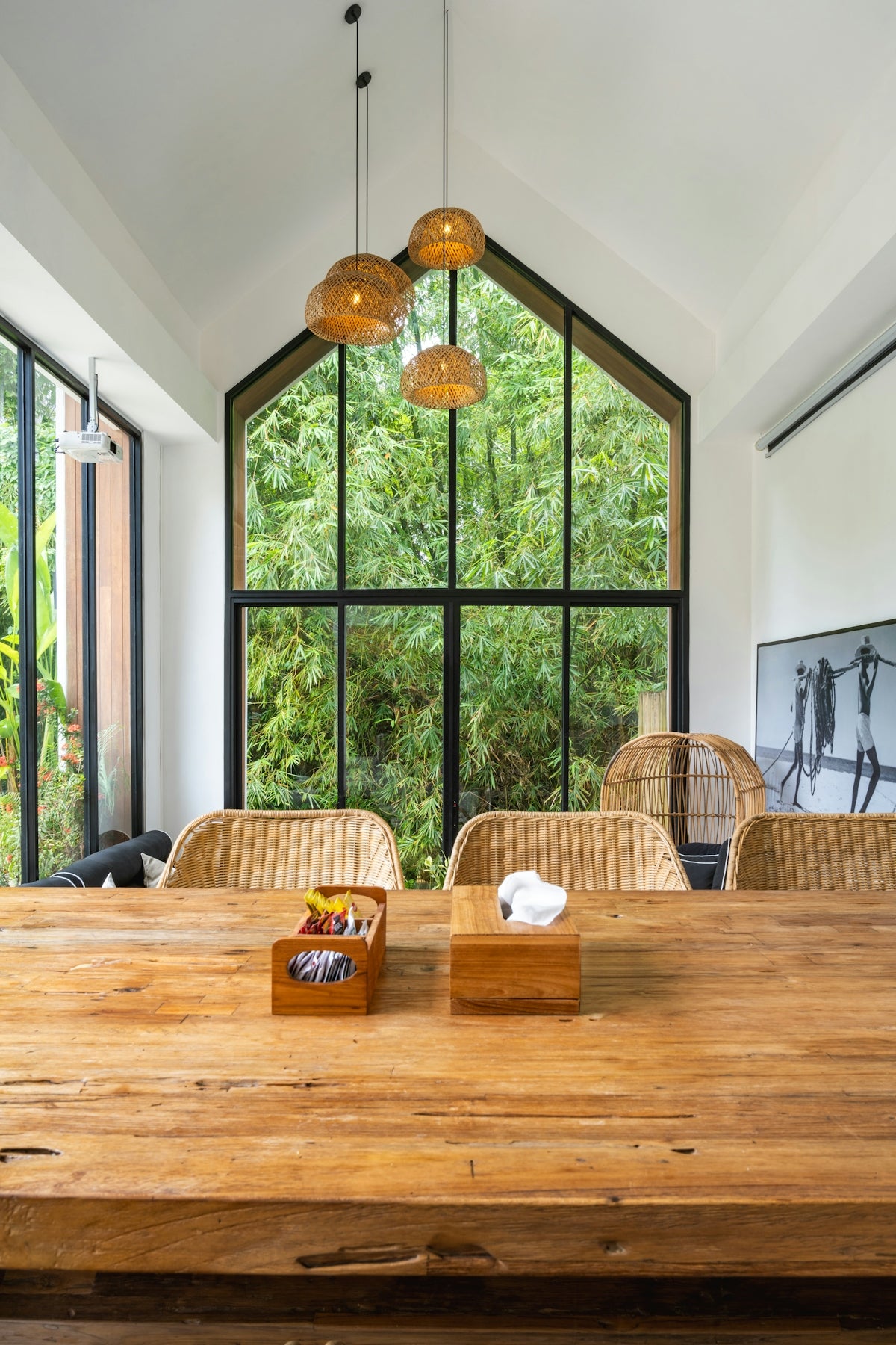 A large wooden table in front of a large window