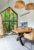 A dining room with a wooden table and chairs