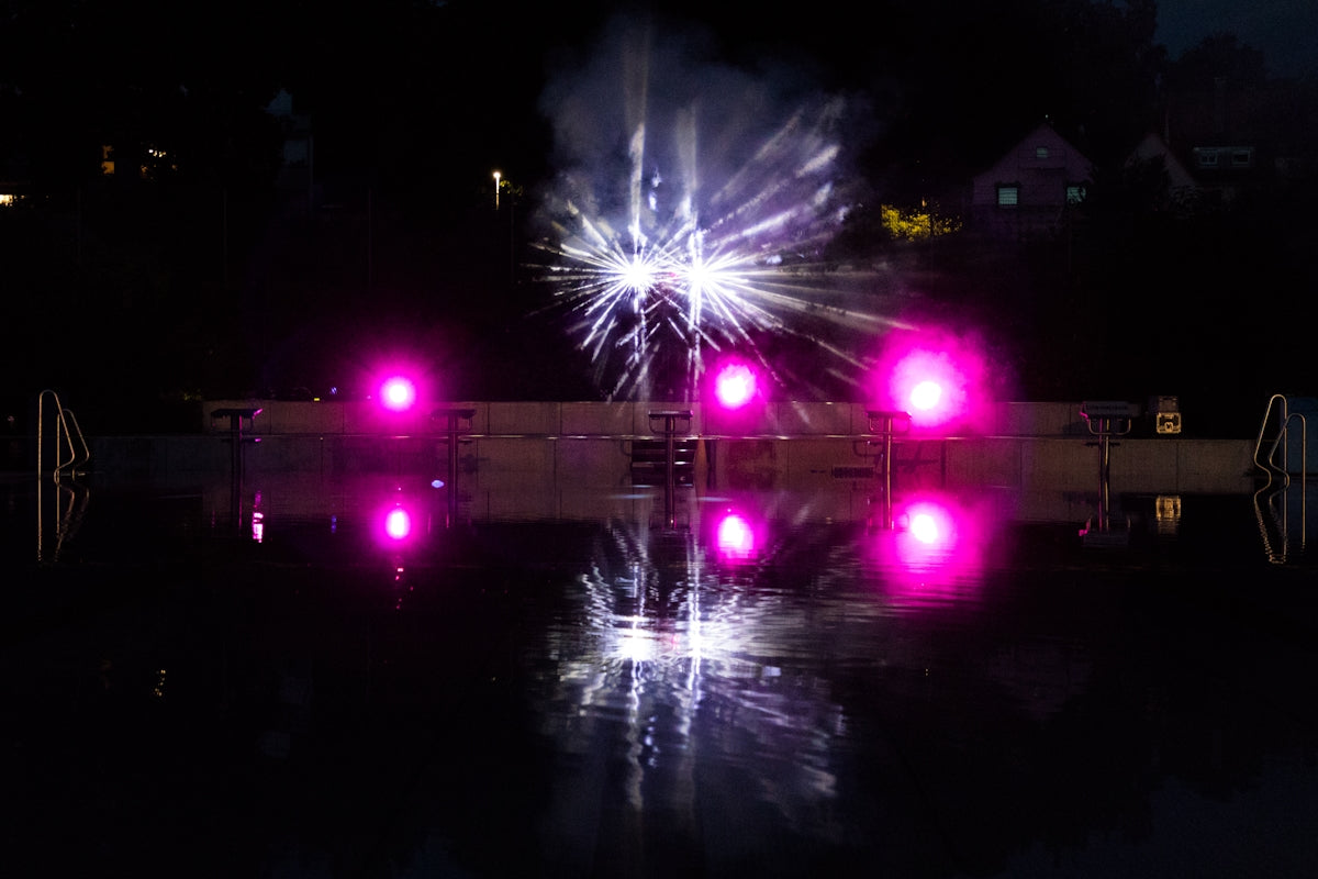 A couple of lights that are on some water