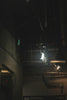 A dimly lit room with exposed pipes and lights