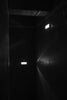 A black and white photo of a dimly lit hallway