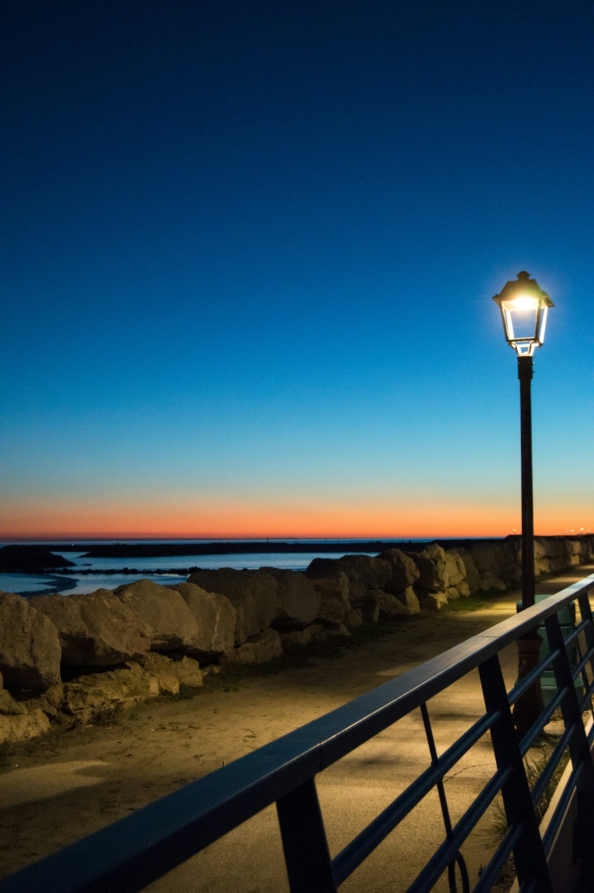 A street light sitting on the side of a road